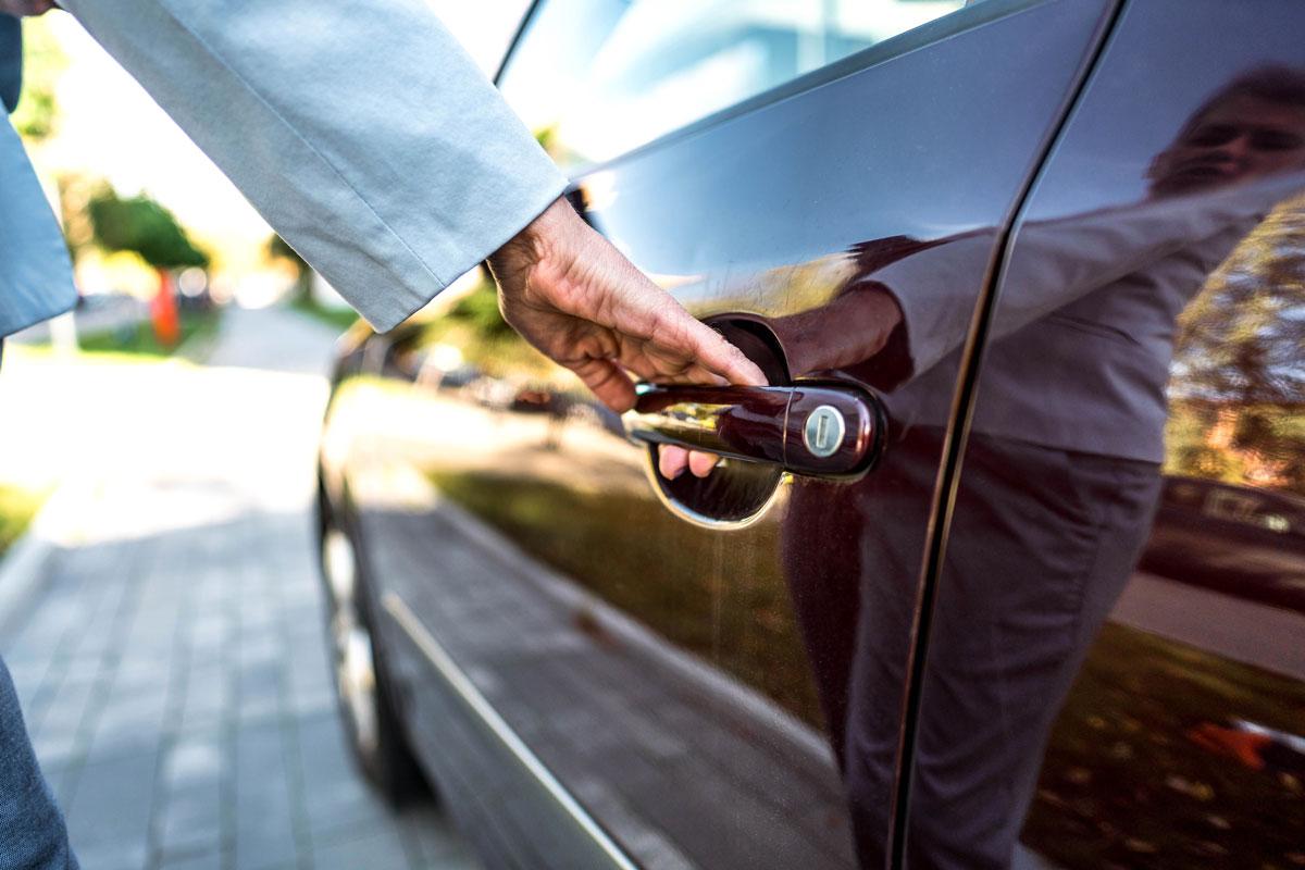 A Man Opening a Locked Car Door After Receiving Automotive Locksmith Assistance in Edmonton, AB